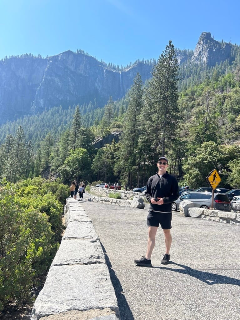 Alex smiling outdoors in Yosemite