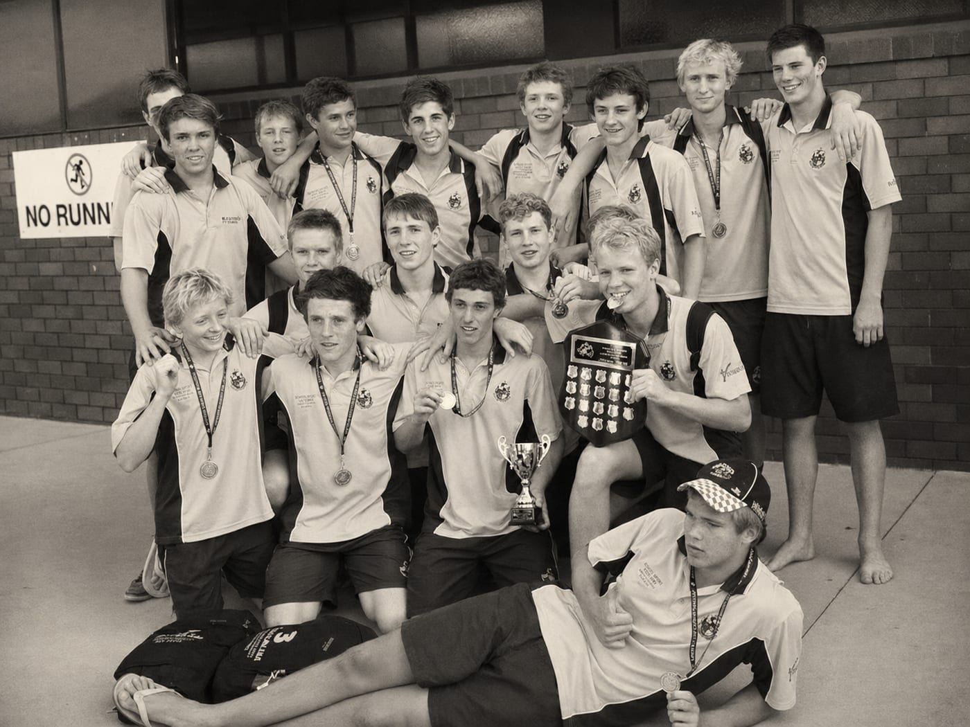 Our junior water polo team with medals and the national championship trophy